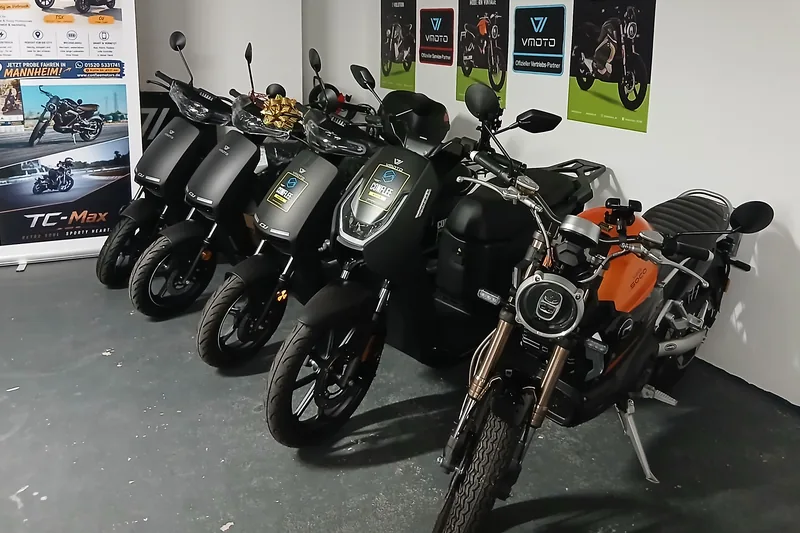 Sechs Elektroroller und E-Motorräder stehen in einer Reihe an der Wand im Showroom in der Augartenstraße in Mannheim.